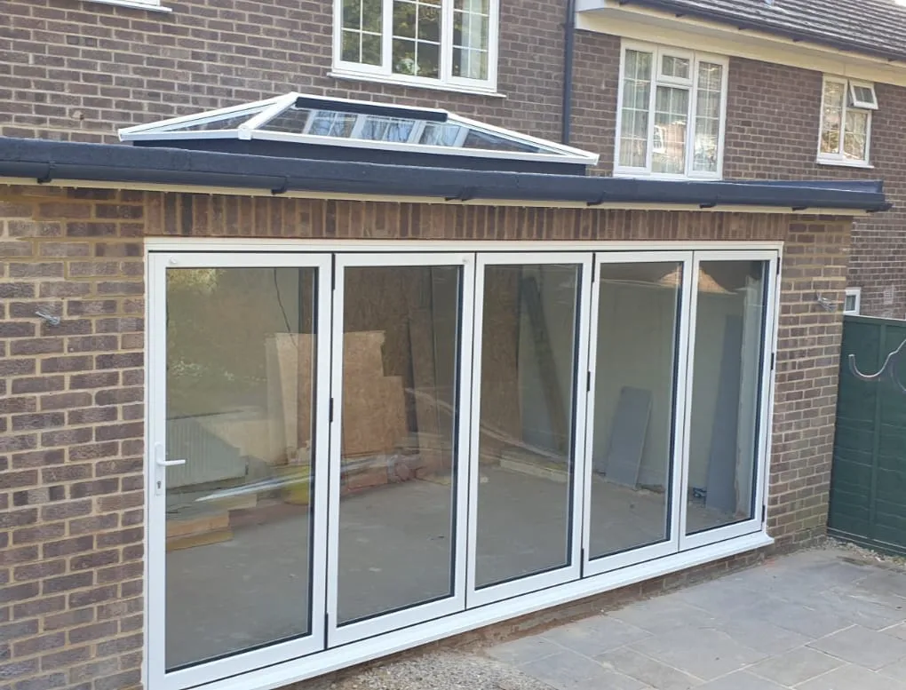 Grey bi-fold doors opening onto a garden room fitted by Everglaze Window Solutions Portsmouth