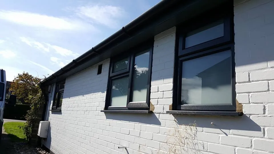 Black framed windows on a modern rendered extension Everglaze Window Solutions Portsmouth