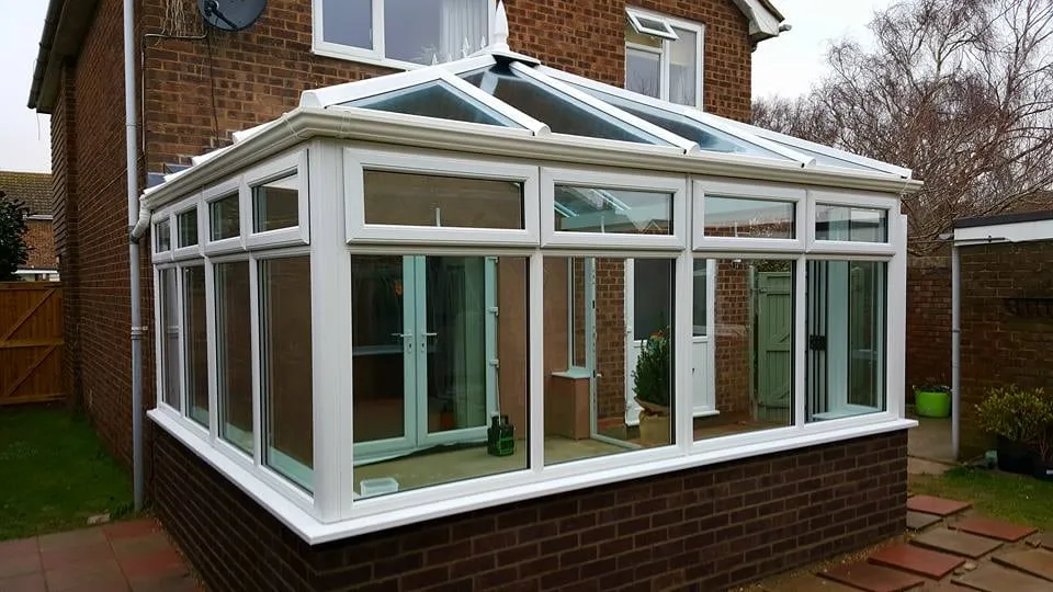 White conservatory overlooking a lawn fitted by Everglaze Window Solutions Portsmouth
