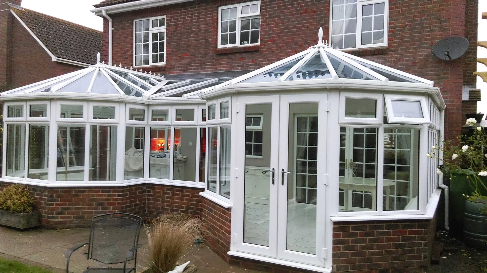 White uPVC Victorian conservatory with glazed roof fitted to a brick home by Everglaze Window Solutions Portsmouth