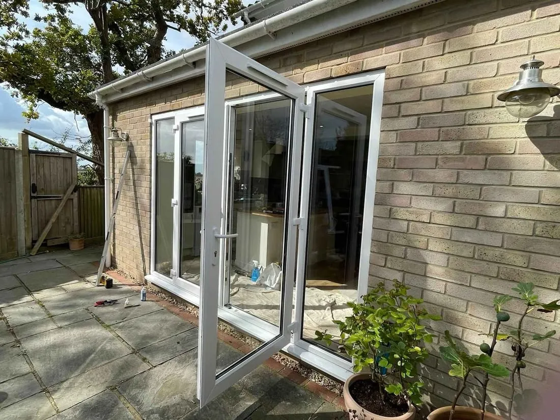 New white windows fitted to a rendered property Everglaze Window Solutions Portsmouth
