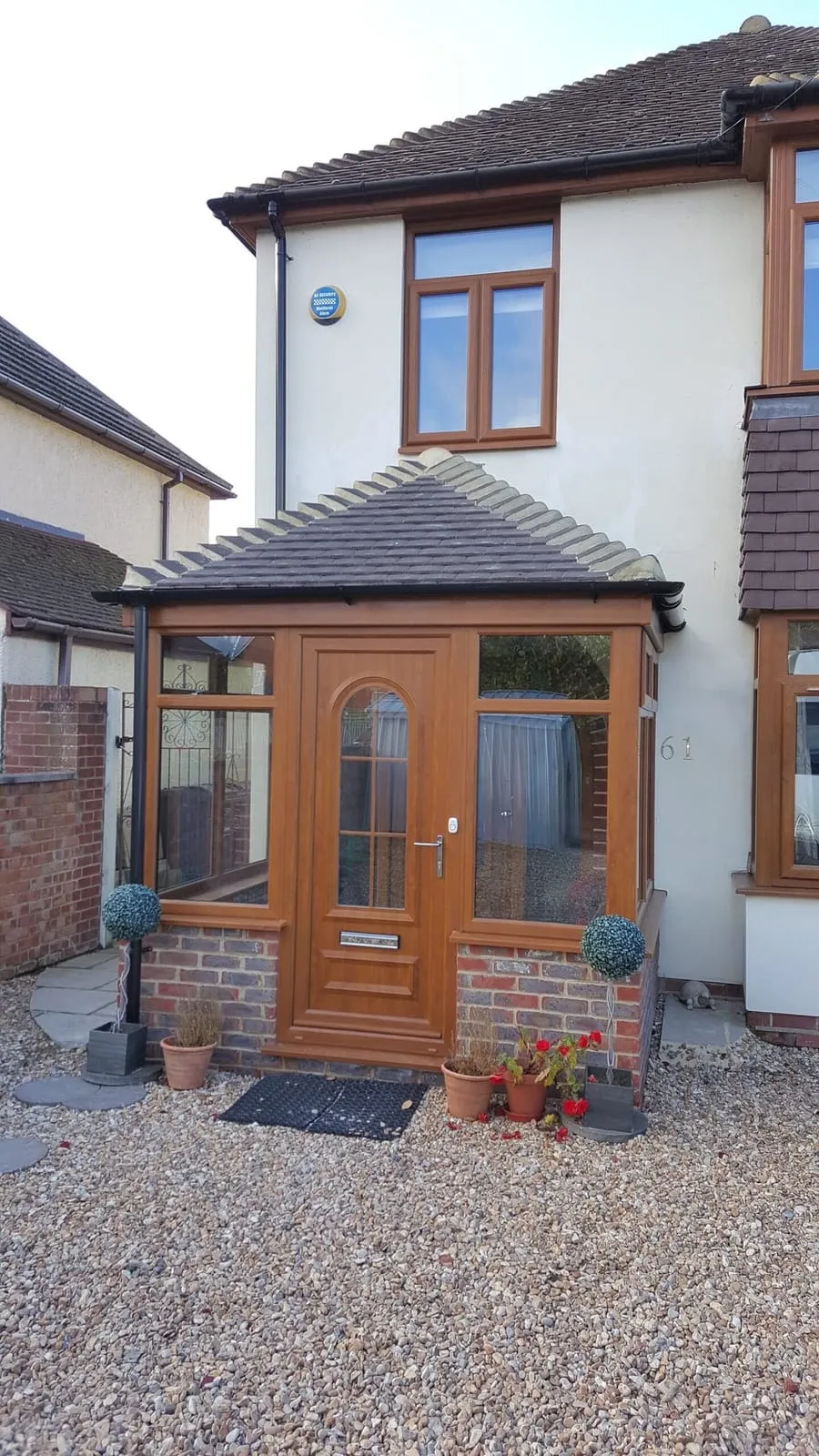 Wooden effect front door inside a brick porch Everglaze Window Solutions Portsmouth